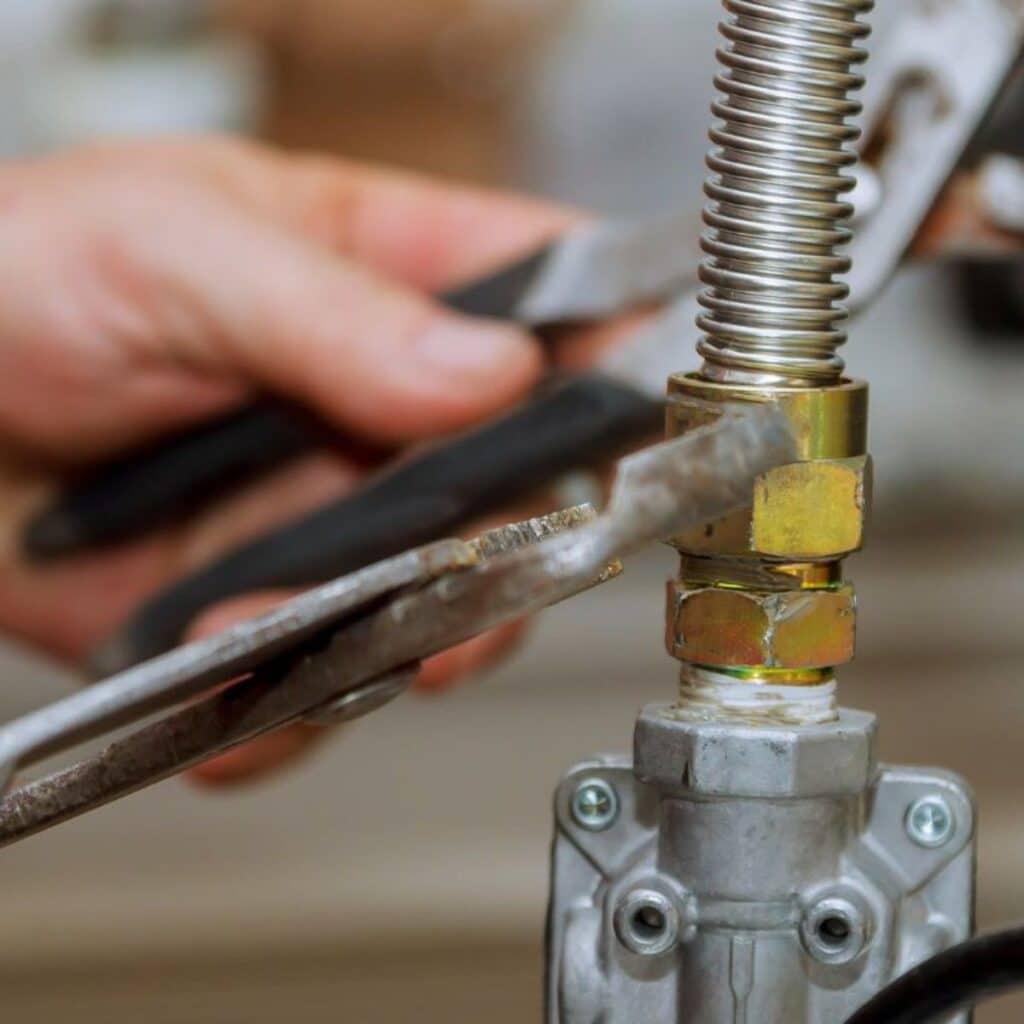 closeup of a technician hand using a wrench to repair a gas plumbing pipe