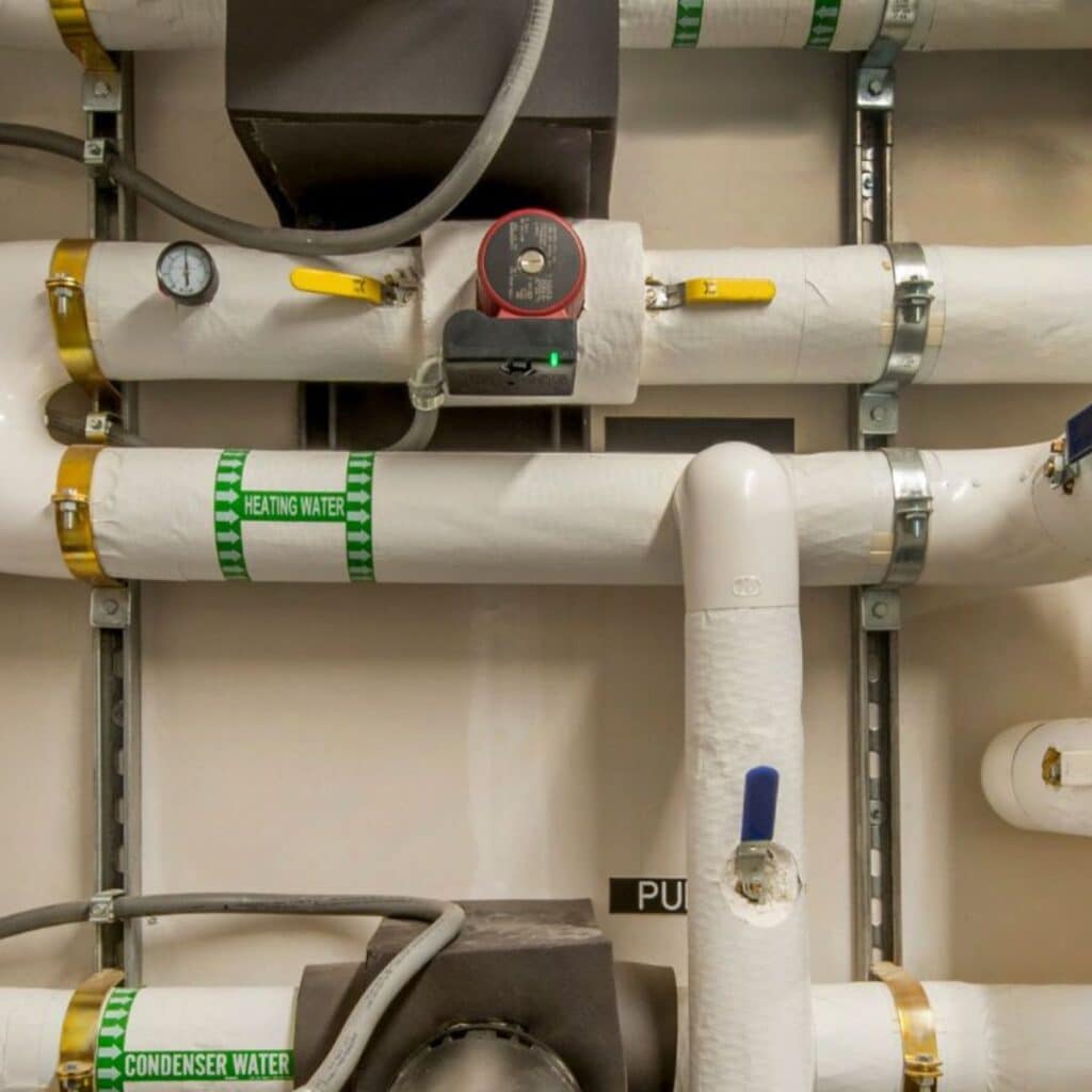 large white tubes used for commercial plumbing with arrows and labels pointing in different directions