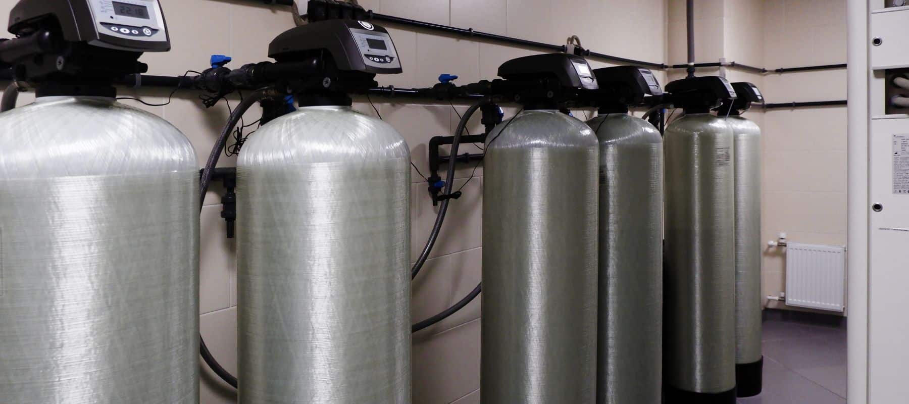 commercial water softeners lined up on a wall in a san antonio commercial business